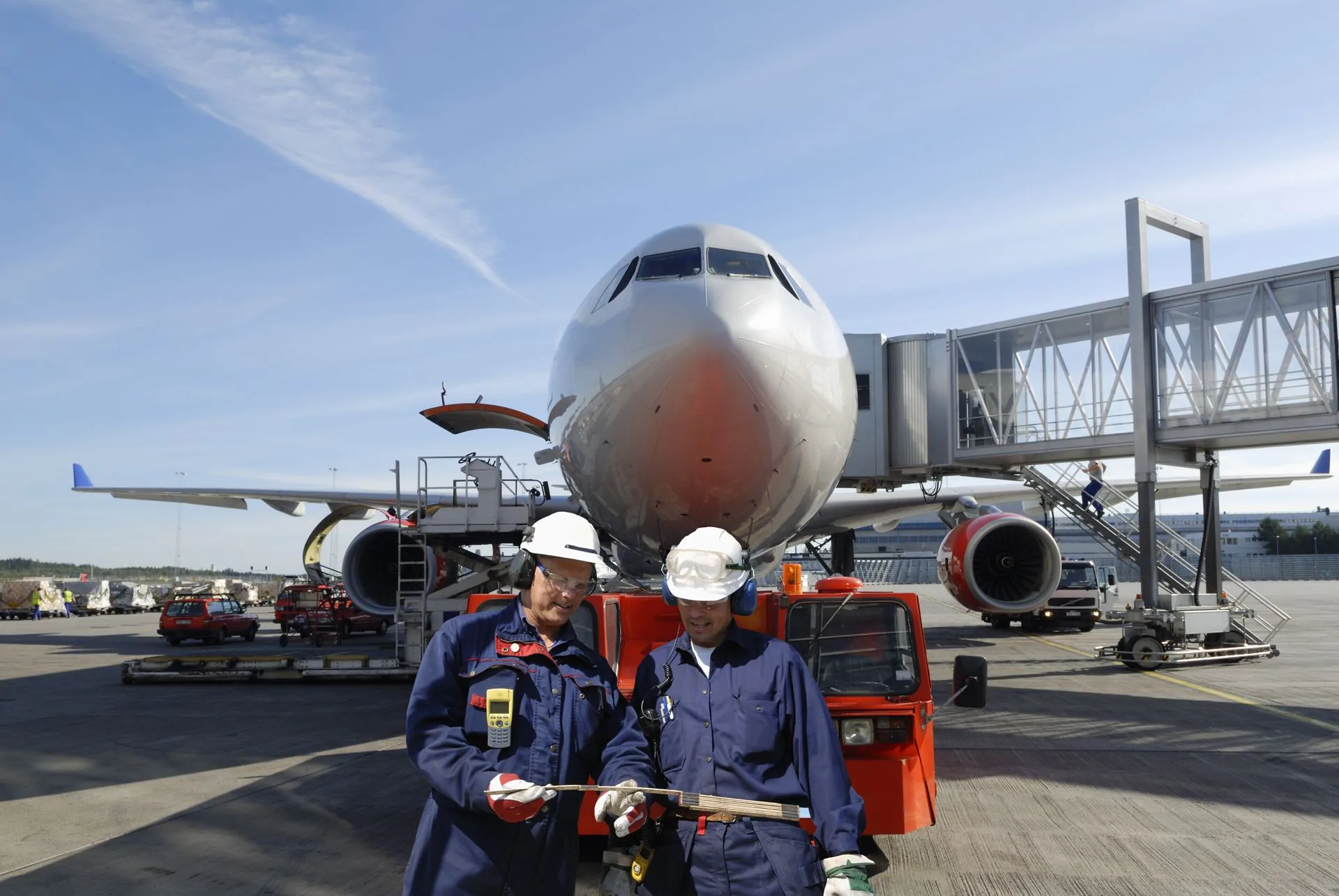 Ground crew servicing an aircraft on the tarmac