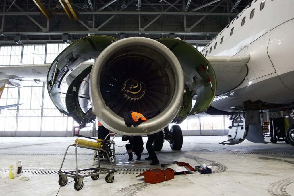 Aircraft undergoing maintenance inspection in hangar